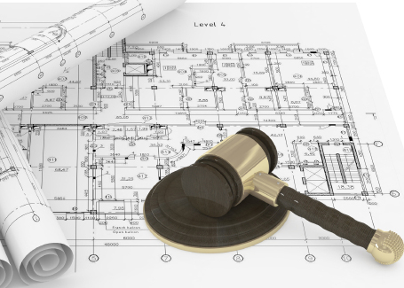Rolled Blueprints and gavel of justice